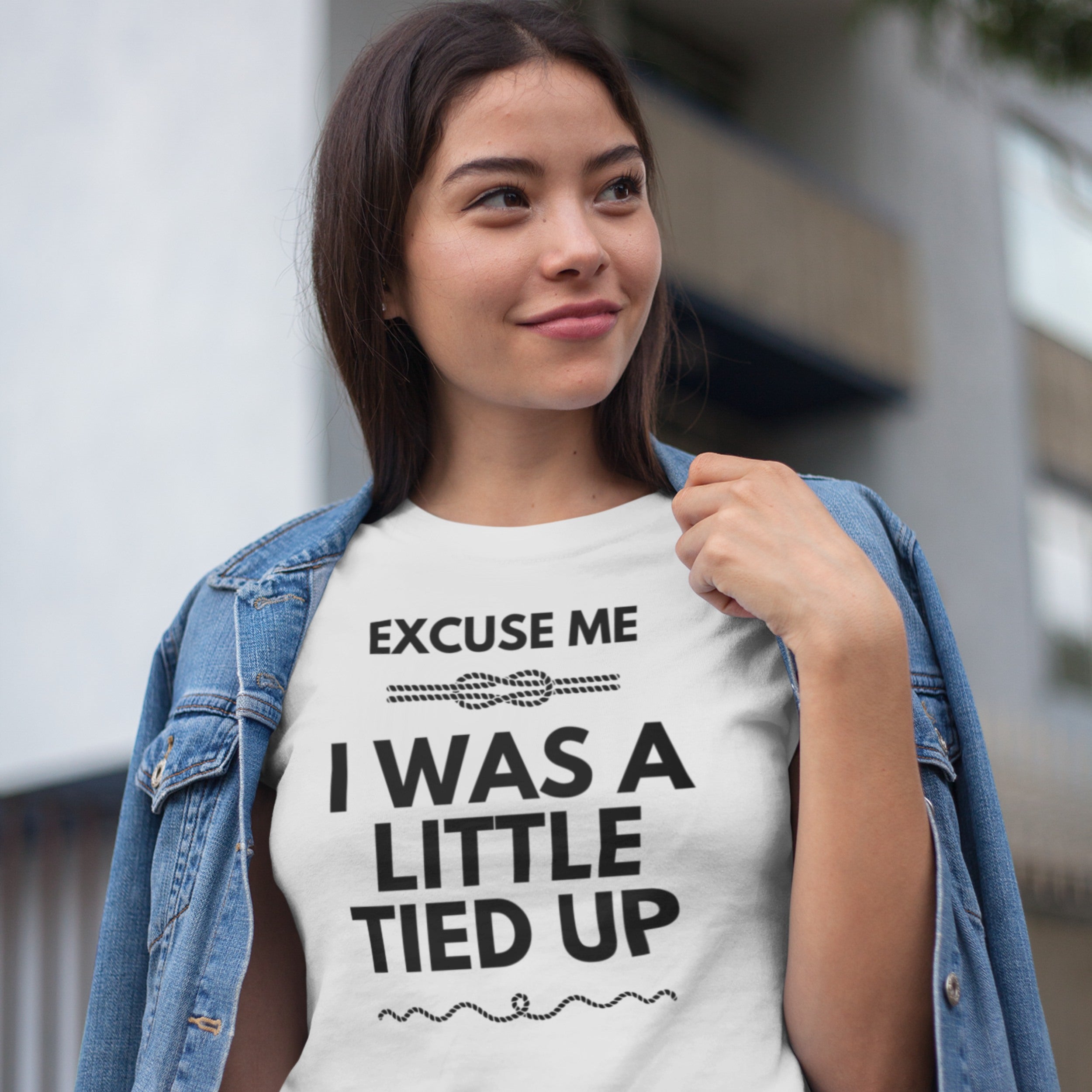 Woman wearing a white t-shirt with text outdoors