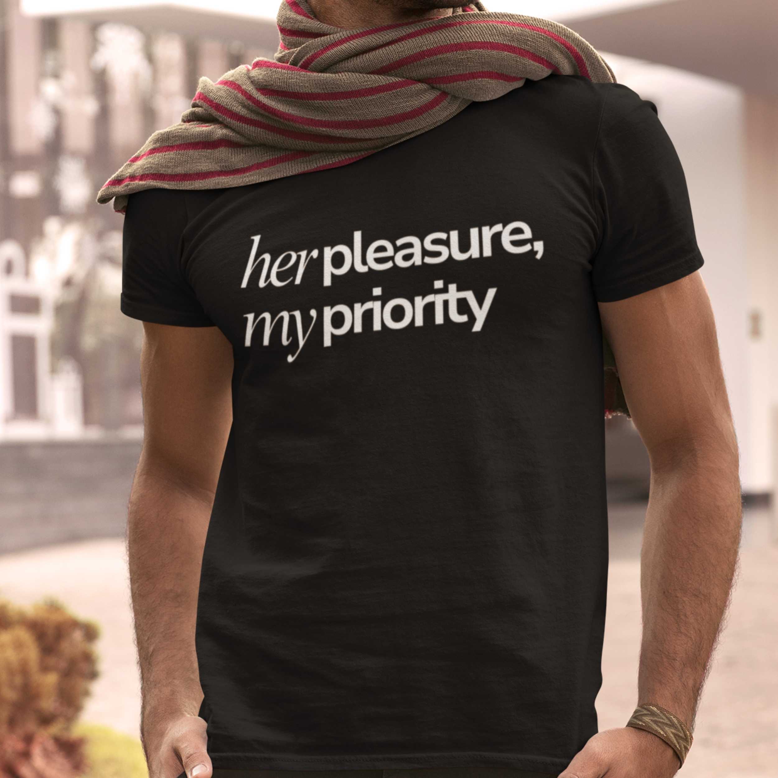 Person wearing a black t-shirt with 'her pleasure, my priority' text.