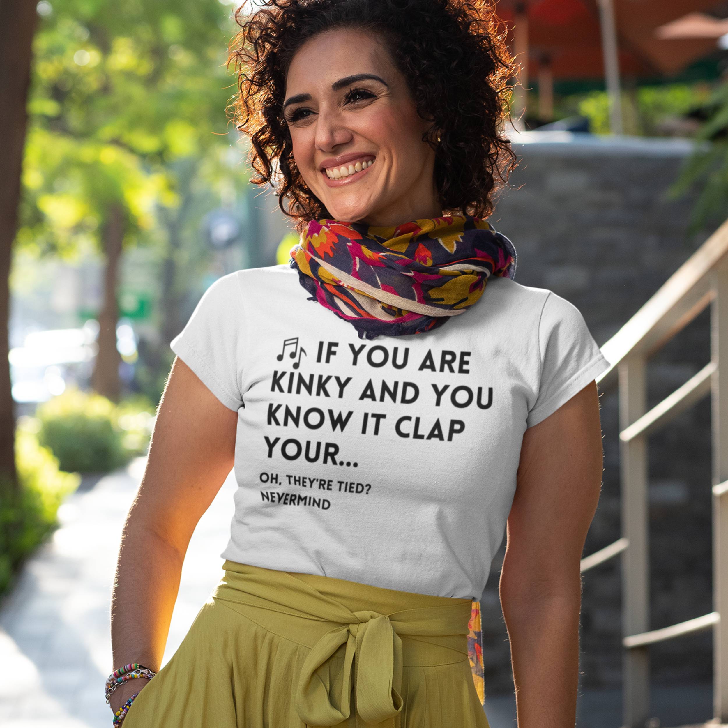 Woman wearing a white t-shirt with text outdoors