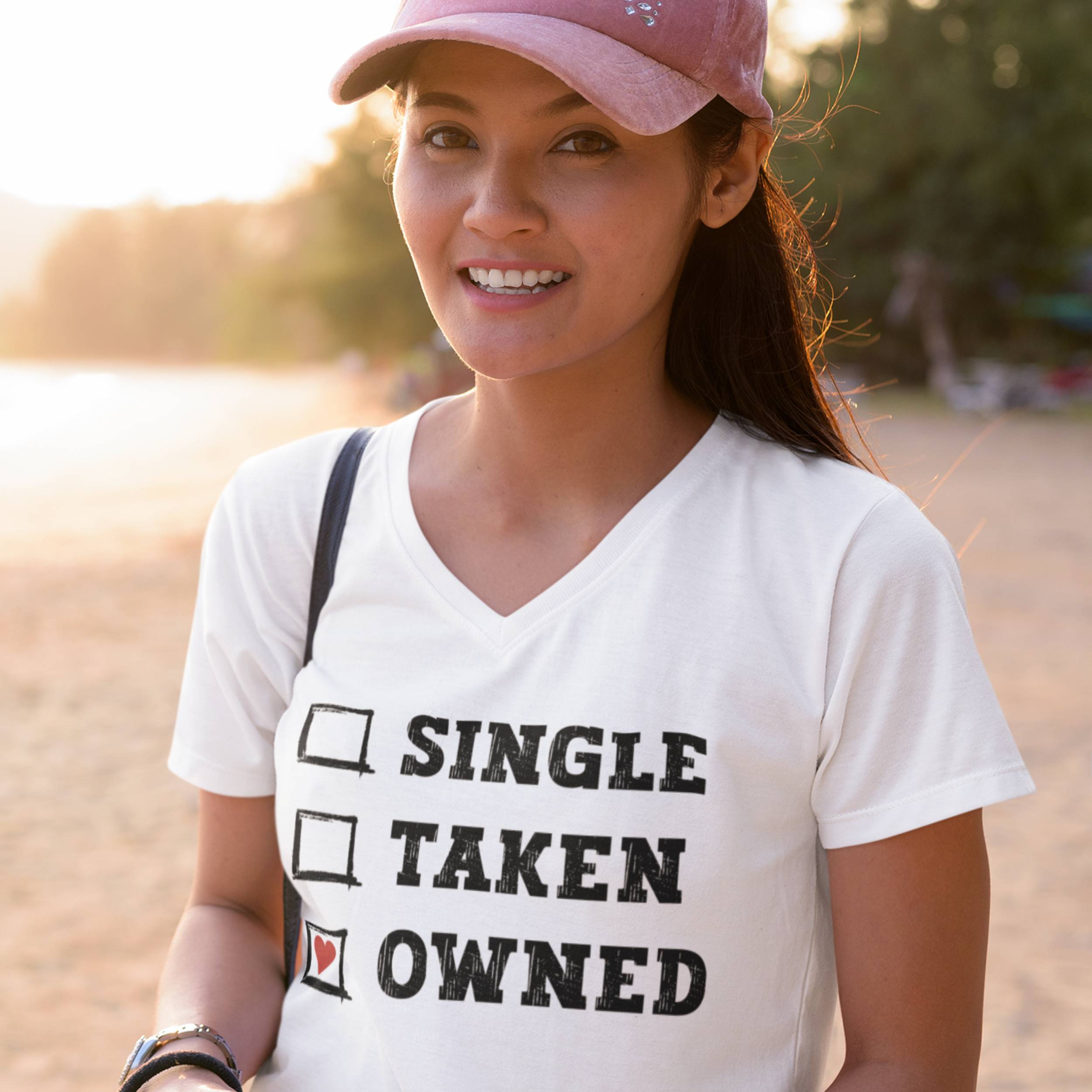 Woman wearing a white t-shirt with text at a beach